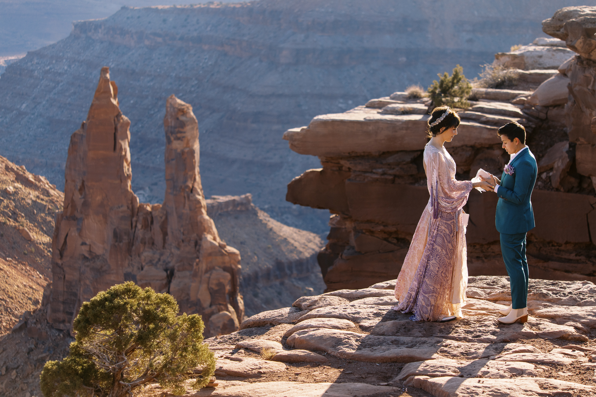 Queer couple sharing a kiss during their elopement in Moab, photographed by LGBTQ+ wedding photographer Desert Paintbrush.
