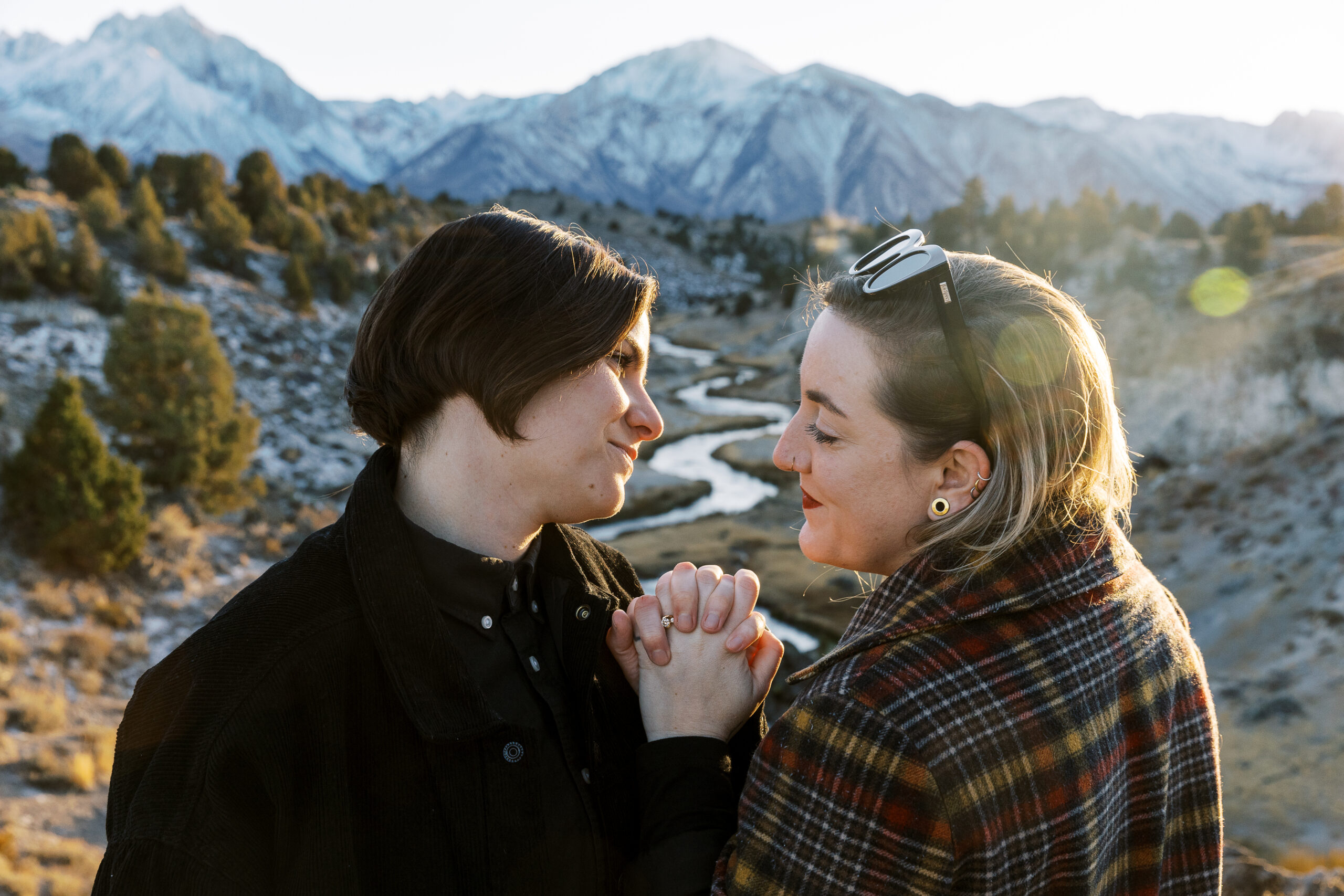 LGBTQ+ couple holding hands during golden hour in the Sierra Nevada, captured by an affirming wedding photographer.