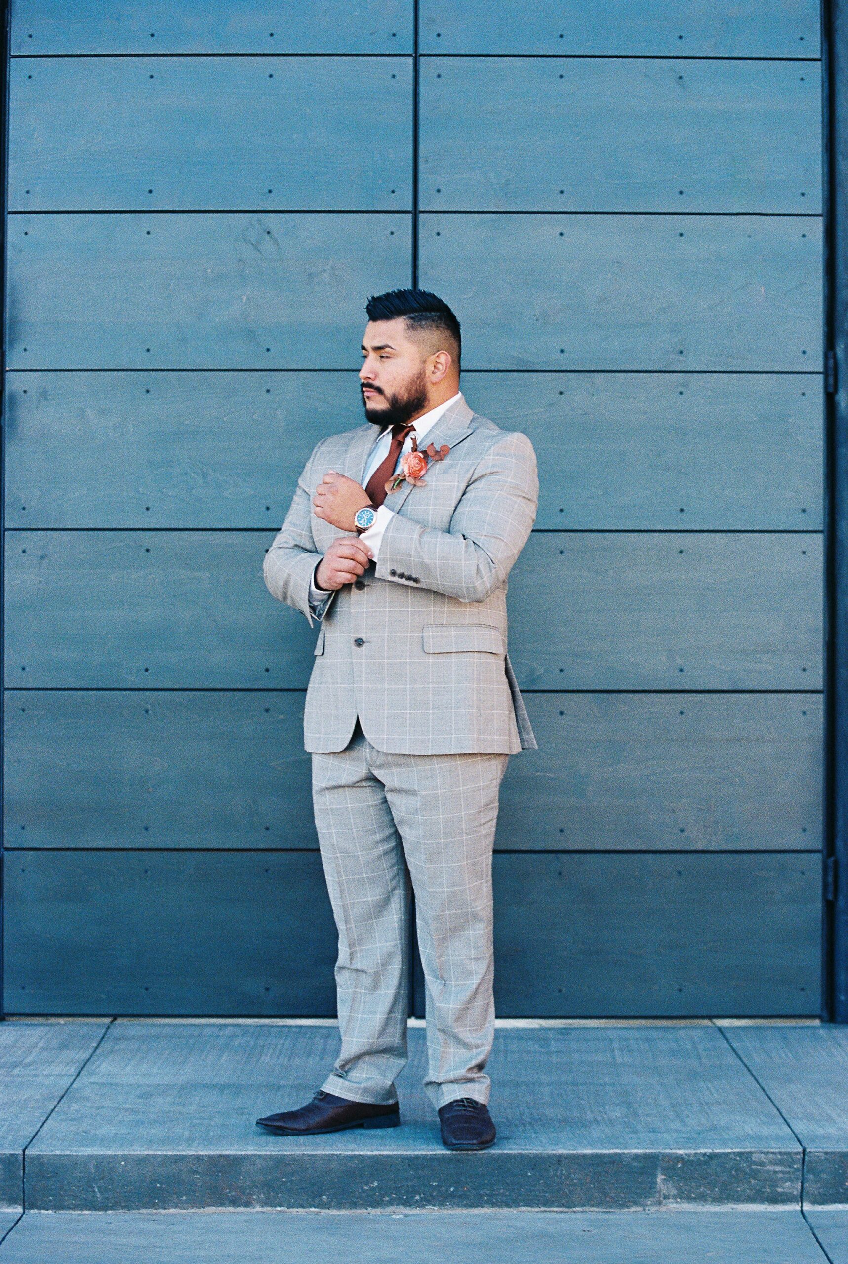 groom outside red earth venue