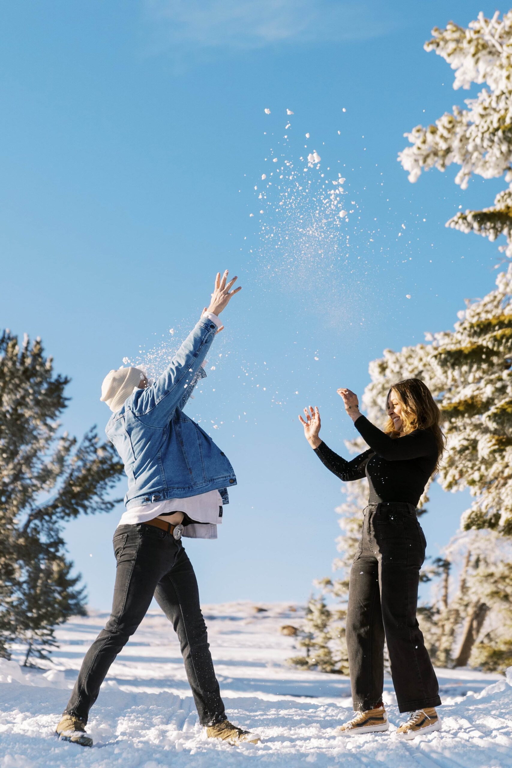 couple throwing snow in the air